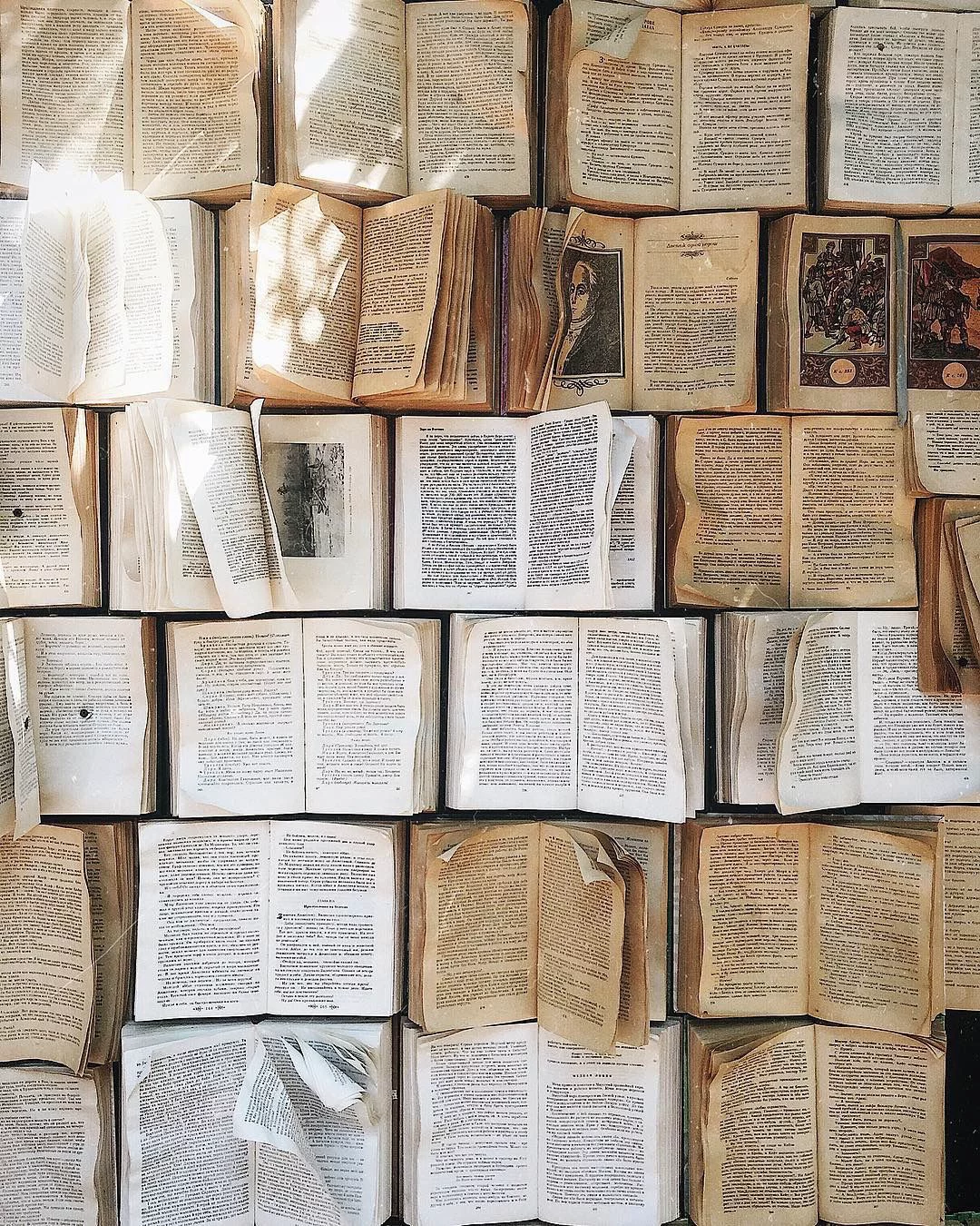 Stacked art and architecture books with two espresso cups